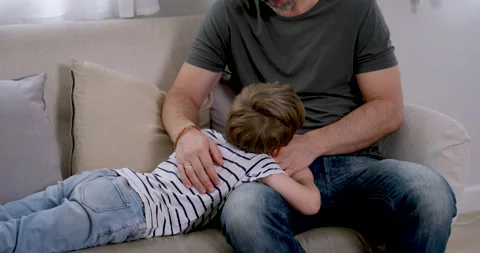 Close view of Caucasian father stroking young son's back and head Stock Footage 340860766