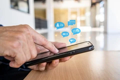 Close-up view of the cell phone in the hands of a man, person using a socia.. 스톡 사진