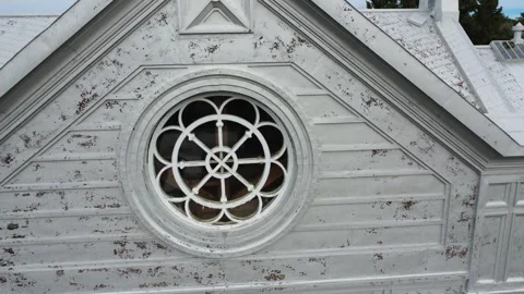 Close-up view of a Celtic cross &amp; a circular Gothic-style rose window. Stock Footage 323094437