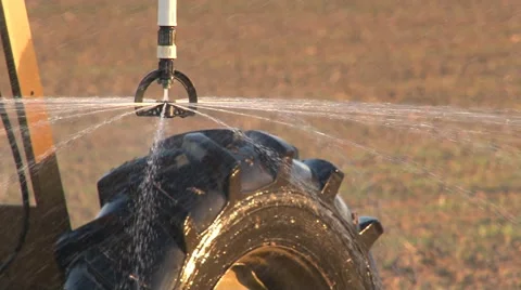 Close up view of center pivot irrigation sprinkler head spraying a moving wheel Video stock 40030696