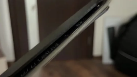 Close-up view of a chainsaws sharp metal chain teeth moving quickly along the Stock Footage 321700266