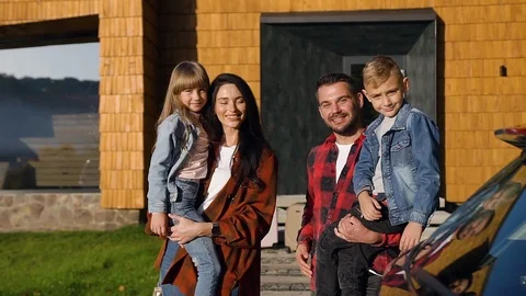Close view of charming happy young family which looking at camera with cute Stock Footage 121661152