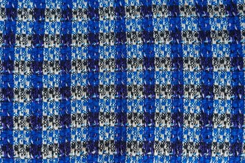 A close-up view of checkered boucle blue and black fabric with intricate texture Stock Photos