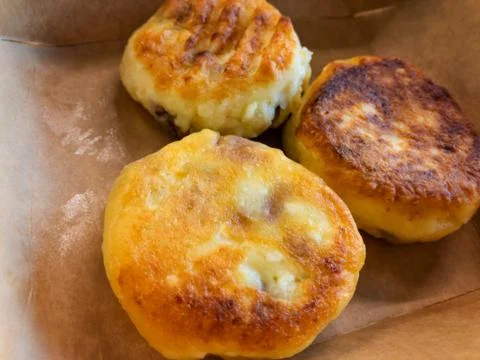 Close view on cheese pancakes lying in opened paper box Stock Photos