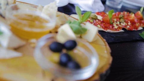 Close up view of cheese plate. Assortment of cheese with walnuts and honey from 스톡 동영상 108726665