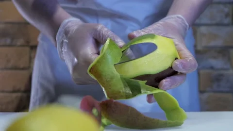 Close up view of the chef in gloves peeling mango. Delisious tropiclal fruit. Video stock 131996474