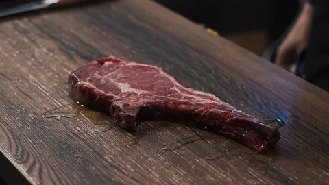 Close Up View Of Chef Pouring Olive Oil Over Raw Meat Steak Tomahawk Only Hands Stock Footage 154558215