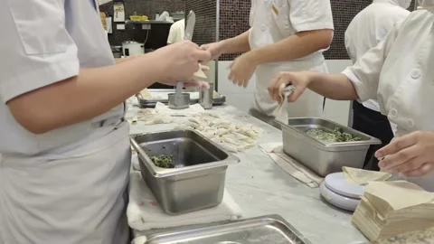 Close-up of view of the chefs making vegetable and pork wontons in the kitchen. 動画素材 239601052