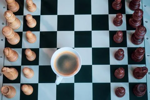 Close-up view of chess board with pieces and cup of coffee Stock Photos