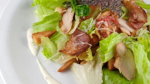 Close-up view of Chicken Caesar Salad, roast chicken fillet, parmesan cheese Stock Footage 80982515
