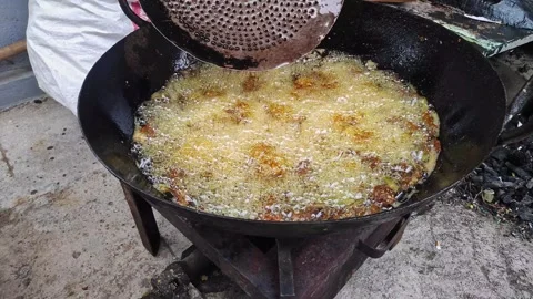 Close-up view of chicken kebabs being fried in hot oil in a large pan on a .. Stock Footage 337037697