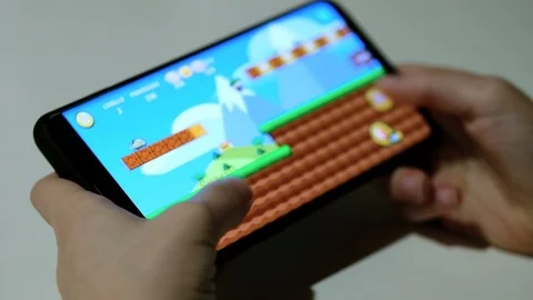 Close up view of Child guy playing mobile games on smartphone, kids education Stock Footage 126786974