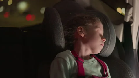 Close View of a Child Peacefully Sleeping in a Car Seat at Night Stock-Footage 280700157