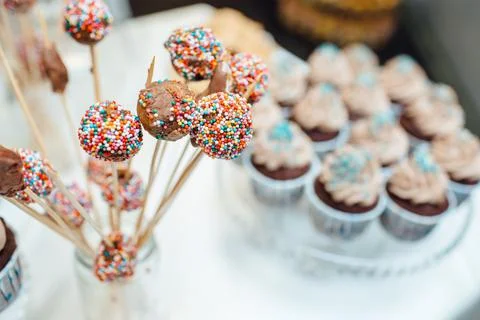 Close-up view of chocolate cake pops decorated with colorful sprinkles on Stock Photos
