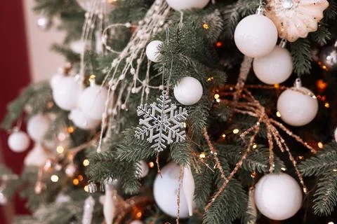 Close up view of christmas tree branches with stylish shiny white baubles, ba Stock Photos