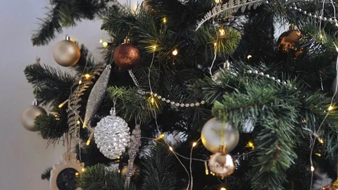 Close up view of Christmas tree ornaments and decorations, light garlands. Stock Footage 98479662