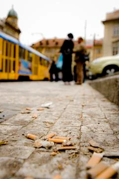 Close up view of Cigarette Butts, sponge filters in a gutter Prague Stock Photos