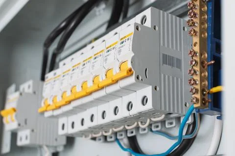 Close-up view of circuit breakers with yellow levers in a distribution panel Stock Photos