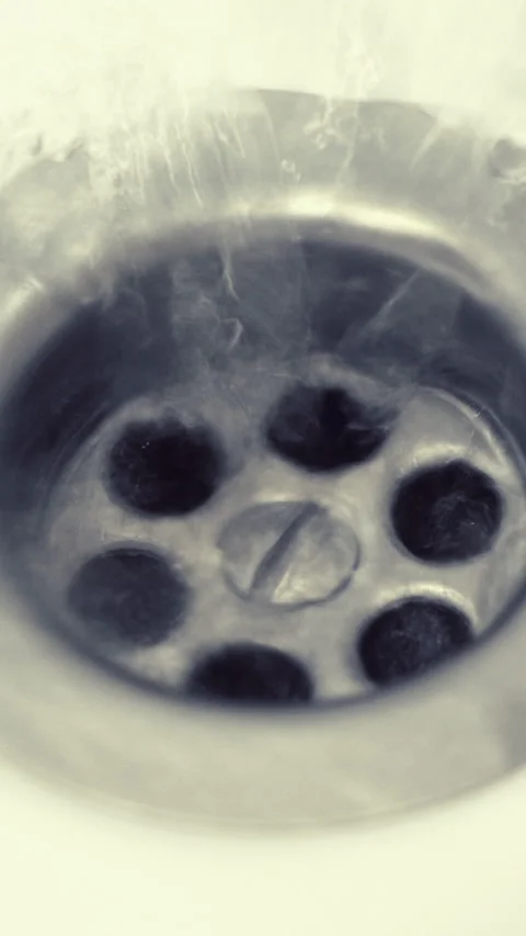 A Close-Up View Of A Circular Metal Sink Drain With Water Flowing Down, Highligh Stock Footage 302540582