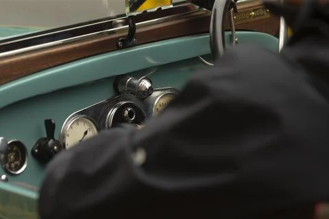 Close view of classic car dashboard with driver Stock Photos