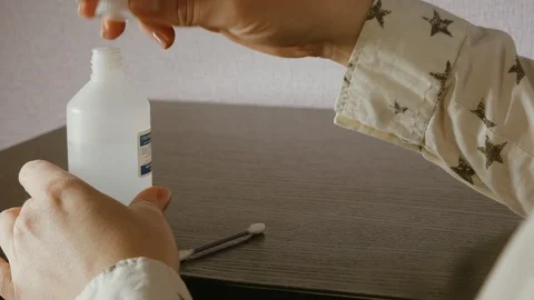 Close-up view to clean the wound on the thumb of the right hand Stock Footage 105303326