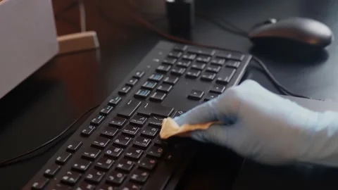 Close up view of cleaning keyboard, using glowes. Covid-19 disinfection concept Stock Footage 151737930