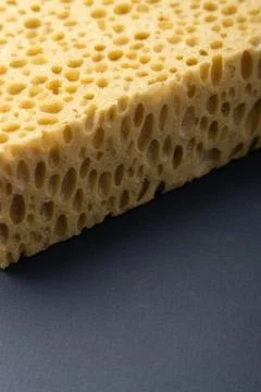Close up view of cleaning sponge, mesh structure pattern on black surface Stock Photos