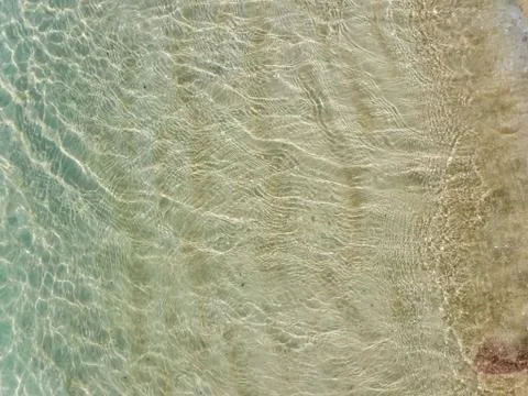 Close up view of clear, transparent, calm and shallow sea water. Providencial Stock Photos