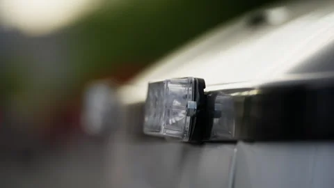 Close-up view of a clear vehicle-mounted light with a blurred background Vídeos de archivo 312508732