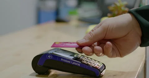 Close view of client paying and using bank card and terminal at cash desk of Stock Footage 153038291