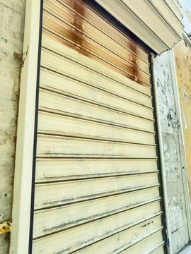 Close view of a closed roller shutter door on a building in a city street d.. Stock Photos