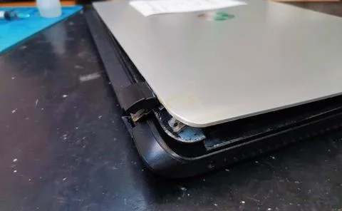 A close-up view of a closed silver laptop computer with its bottom plastic 스톡 사진