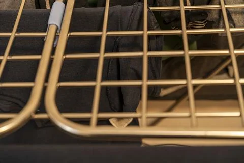 Close-up view of clothes drying on a golden drying rack, showcasing neatly Stock-Fotos