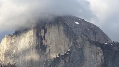 Close up view of cloud-covered Half Dome from Yosemite Valley Stock Footage 241194112