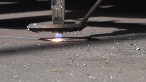 Close up view CNC plasma cutter torch moves and arc cuts metal. Stock Footage 140736087