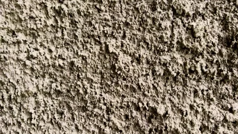 Close view of a coarse weathered concrete wall with rugged natural texture. Stock Footage 340115517