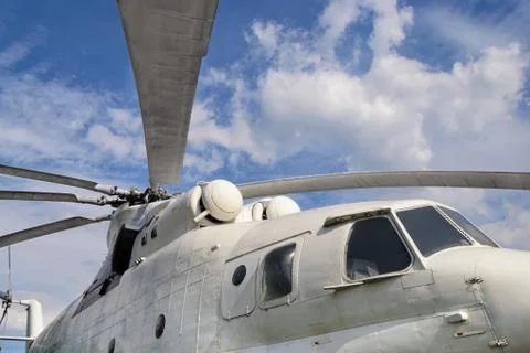 Close-up view on cockpit of a big white cargo helicopter on cloudy sky backgr Stock Photos