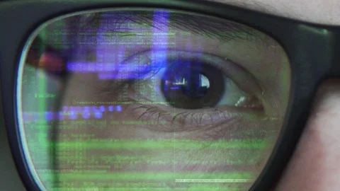 Close up view of a coding text reflecting on the glasses in green color Stock Footage 108751881