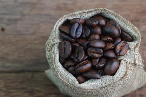 Close up view of coffee bean brown roasted isolated on a wooden background Stock Photos