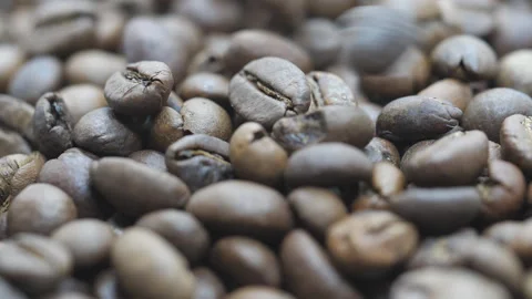 A close up view of coffee beans falling on pile. Stock Footage 166813209