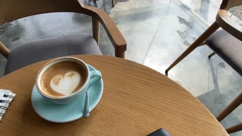A close up view of coffee latte in a green cup on the table. a view in the cafe. Stock Footage 214114737