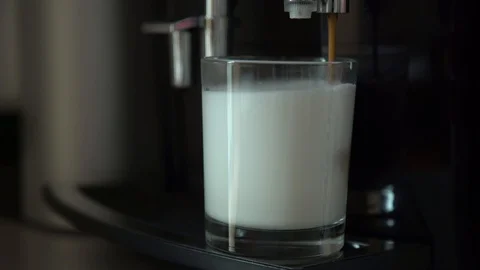 Close up view of coffee running from the capsule coffe machine into cup Stock Footage 129557987