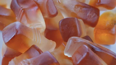 Close up view. Cola bottle shaped soft jelly bean candies. Slider shot. Stock Footage 296536346