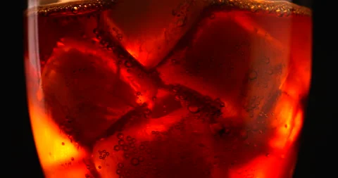 Close up view of Cola in a glass with ice cubes. Filmed in slow motion with RED Stock Footage 153663419