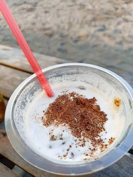 Close-up view of cold coffee drink with latte art sprinkles in a plastic cup wit Stock Photos