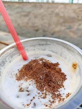 Close-up view of cold coffee drink with latte art sprinkles in a plastic cup wit Stock Photos