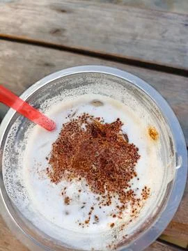Close-up view of cold coffee drink with latte art sprinkles in a plastic cup wit Stock Photos