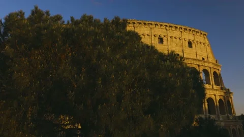 Close-up view of Coliseum at the sunset, behind the tree, 4K Footage Stock Footage 153955921