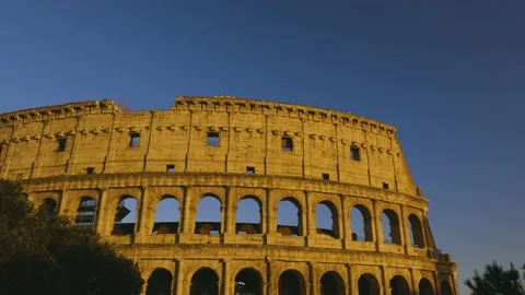 Close-up view of Coliseum at the sunset, behind the tree, 4K Footage Stock Footage 153955963