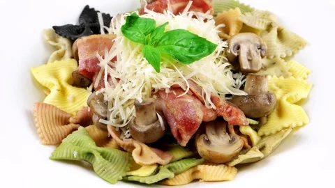 Close-up view of colored bowtie pasta with parmesan cheese, mushrooms Stock Footage 73654725